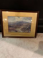Front view of framed print showing image, mat, and brown wood frame