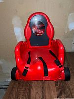 Front view showing overall booster seat, decal, straps