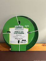Front view of coiled hose showing brand label and price tag