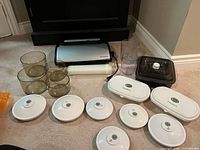 All items laid out on floor showing sealer, canisters, lids, bag roll, hose