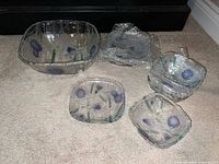 Entire 7-piece glass set laid out on carpet