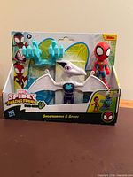 Front of sealed package showing Spider-Man figure, Ghostasaurus figure and accessories