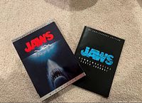 Slipcover and inner case/booklet of Jaws Special Edition DVD shown on carpet