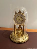 Full view of Kern torsion clock under glass dome