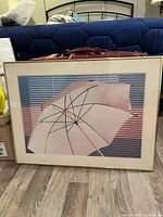 Front view showing umbrella print, mat and gold frame