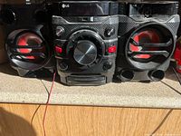 Front view of LG stereo system showing main unit and both speakers