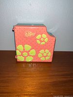 Closed playset showing coral exterior and flower motifs