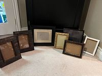 Group shot of all seven frames standing on carpet