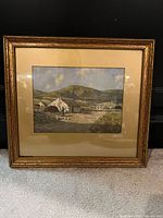 Front view of framed watercolor landscape in gold-tone frame