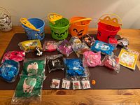Full lot showing buckets, sealed toys and pins