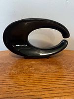 front view showing abstract loop shape and black glaze