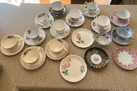 Overview of tea cups on saucers and separate saucers