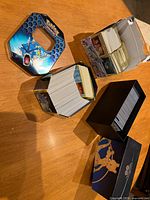 Bulk cards in two tins, black card box, and Chilling Reign box
