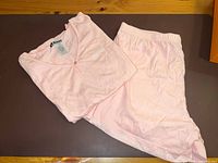 Folded Roots pajama top and pants laid out showing full set
