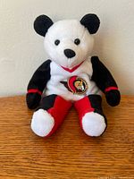 Front view of plush bear showing Ottawa Senators logo and color scheme