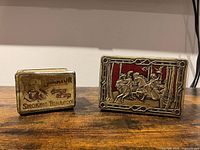Front view of both tins showing Senator label and embossed decorative scene
