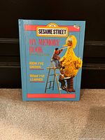 Front cover showing title, Sesame Street logo, characters, general wear