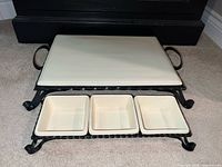 Full set assembled: platter atop stand, three bowls in frame