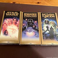 Front artwork of the three gold Special Edition VHS tapes
