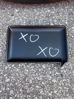 Front view showing black speech-bubble tray with chalk writing