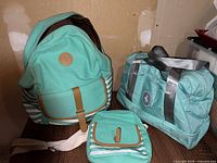 Backpack, duffel bag and crossbody pouch grouped