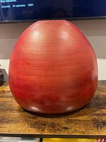 Front view of red burgundy resin vase