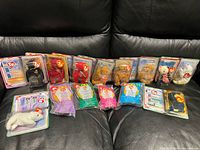 Full lot on couch: 13 carded Beanie Babies, 4 polybag Teenie Beanies, 3 blister items front