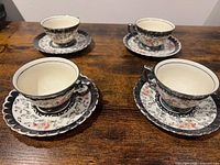 Four teacups each on their saucers showing pattern and trim