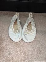 Top view of both ballet flats showing lace trim and rhinestone detail