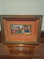 Front view of gilt frame with miniature painting and velvet mat