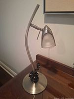 Full view of chrome desk lamp on surface