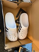 Top view of both clogs inside original box