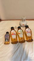 Lamp, four refill bottles arranged on cloth