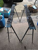 Pair of unfolded steel sawhorses standing