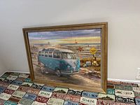 Front view showing completed puzzle of VW van beach scene in wood frame with glass
