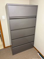 Full view of gray 4-drawer lateral file cabinet