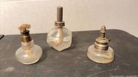 Frontal view of all three miniature spirit lamps showing shapes and burners