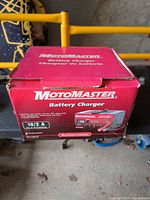 Retail box showing MotoMaster Battery Charger branding and specifications