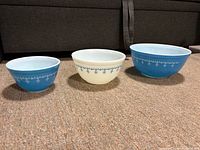 Set of three Pyrex Snowflake Garland mixing bowls shown side-by-side