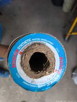 End view of Resister synthetic roofing underlayment showing label, cardboard core, remaining material