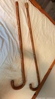 Both wooden crook-handle canes side by side