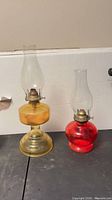 Both lamps side by side showing overall form, colors and chimneys