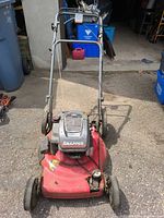 Full front view of Snapper mower showing deck, engine, handle