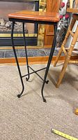 Full view of side table showing wood top and metal legs