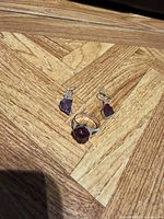 Ring and earrings full view on wood surface