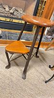 Full view showing round seat, triangular step, metal frame