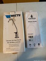 Watts and Express Water faucet boxes front view