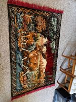 Full view of rug showing wildlife scene and border