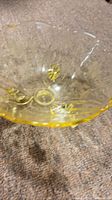 Top view showing entire yellow amber glass bowl with etched design
