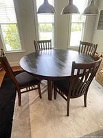 Full dining set showing table and four chairs